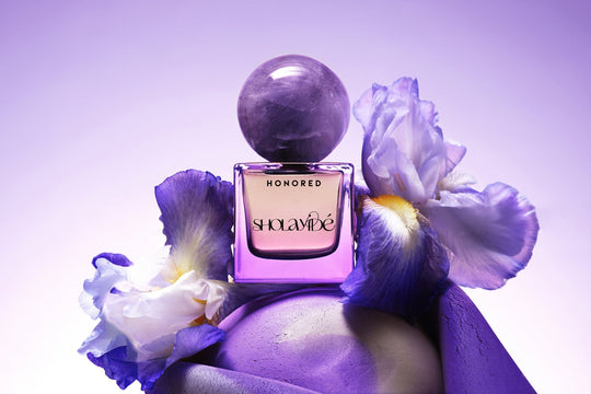 HONORED by SHOLAYIDÉ, eco-luxe eau de parfum purple ombre bottle with amethyst crystal cap on white background.