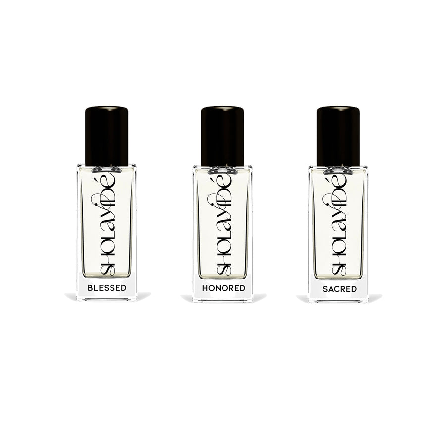 UPLIFTED by SHOLAYIDÉ, an eco-luxe eau de parfum travel set with 3 glass bottles standing upright on white background.