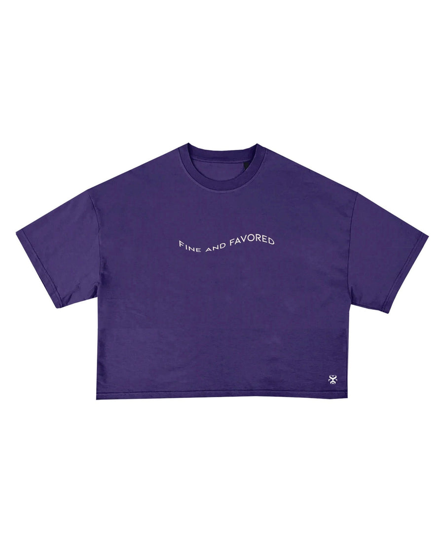 FAVORED purple cropped tee with fine and favored embroidery by SHOLAYIDÉ laying flat on white background. 