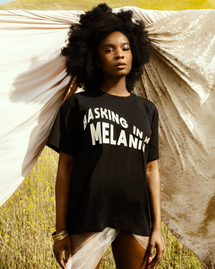 Our MELANIN t-shirt celebrates the poised & magical Black woman with an embroidered, wavy design of 