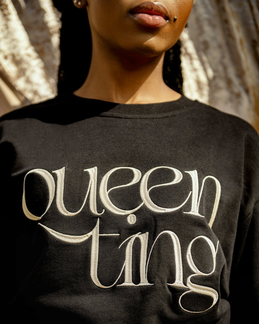 Close up of beautiful black female model wearing the black Queen Ting embroidery sweatshirt by SHOLAYIDÉ.
