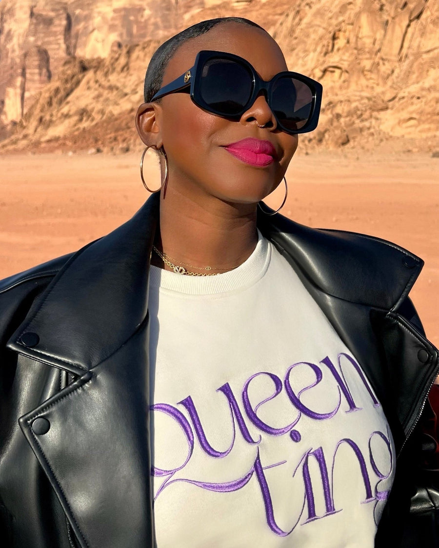 Founder, Sholayide Otugalu in the Wadi Rum desert wearing the cream Queen Ting embroidery sweatshirt by SHOLAYIDÉ.