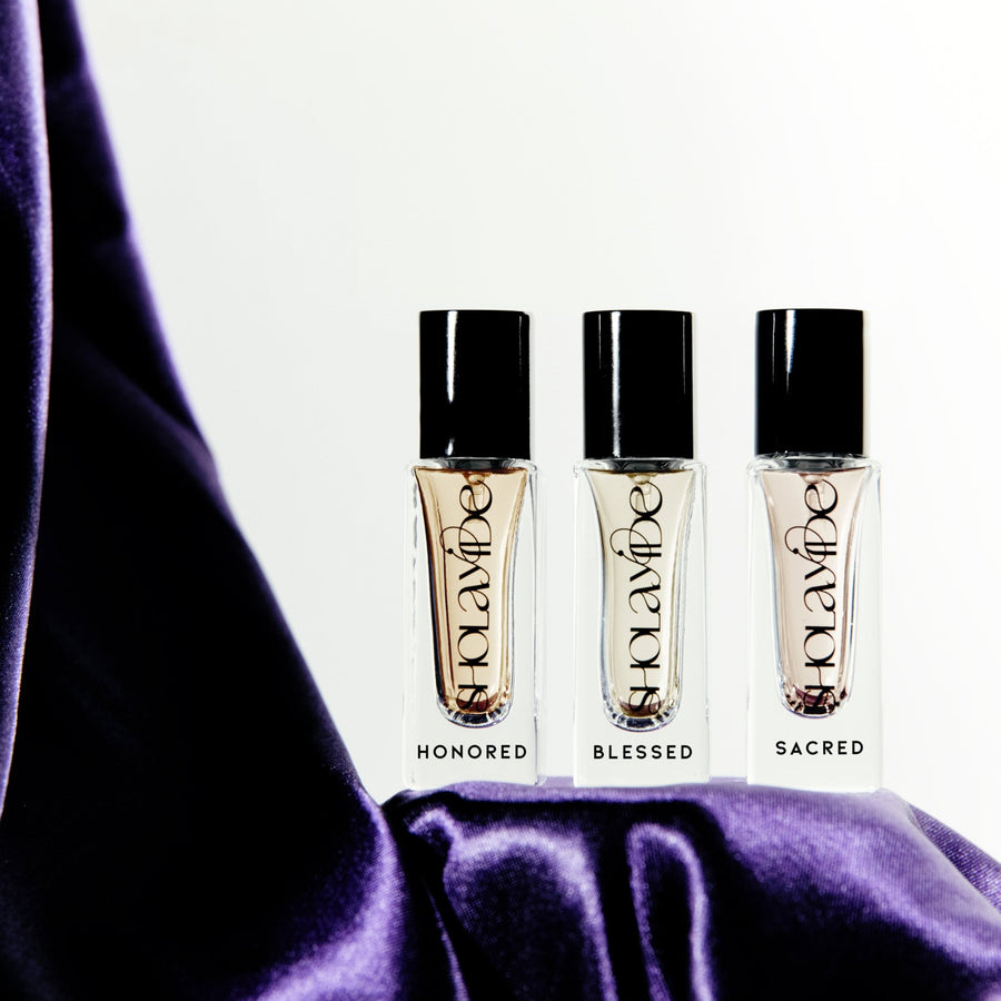 UPLIFTED by SHOLAYIDÉ, an eco-luxe eau de parfum travel set with 3 glass bottles standing upright on white background.